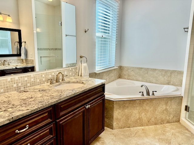 full bath with vanity, decorative backsplash, a shower stall, tile patterned flooring, and a bath