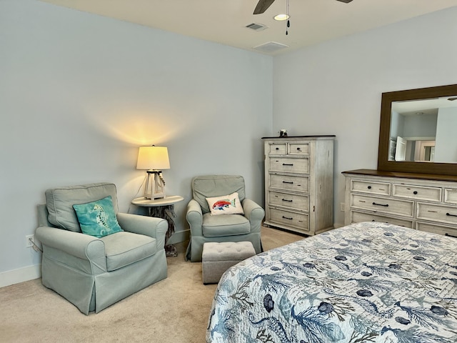 bedroom with visible vents, light colored carpet, baseboards, and ceiling fan