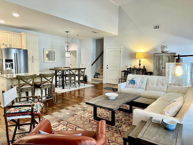 living room featuring recessed lighting, stairway, visible vents, and wood finished floors