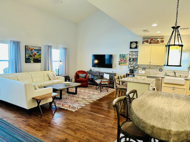 living room with recessed lighting, visible vents, high vaulted ceiling, and dark wood finished floors