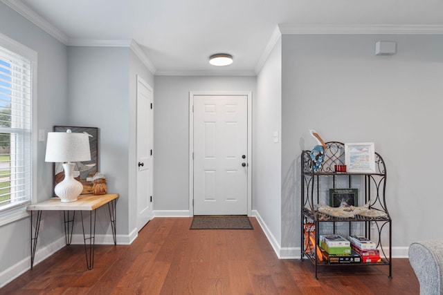 foyer entrance with crown molding, baseboards, and wood finished floors