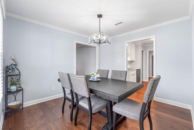 dining area with visible vents, crown molding, baseboards, a chandelier, and wood finished floors