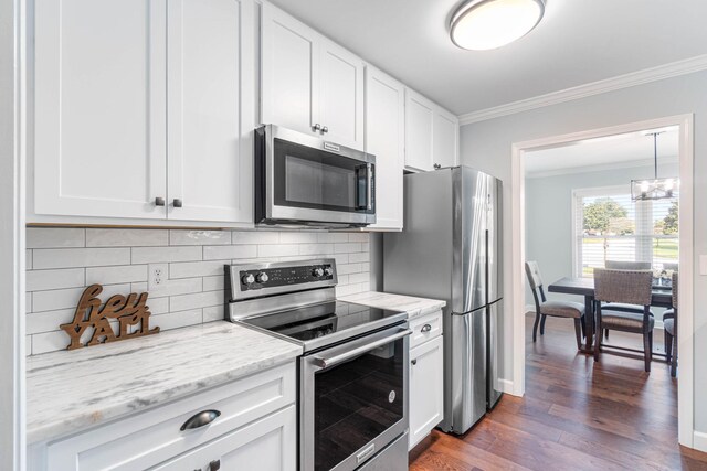 kitchen with dark wood-style floors, appliances with stainless steel finishes, white cabinetry, and crown molding