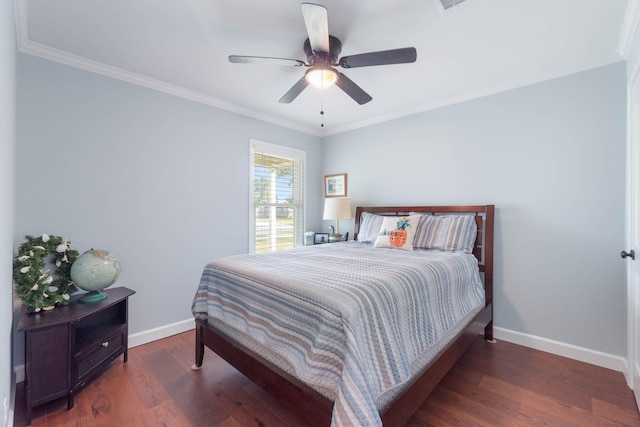 bedroom with baseboards, a ceiling fan, wood finished floors, and crown molding