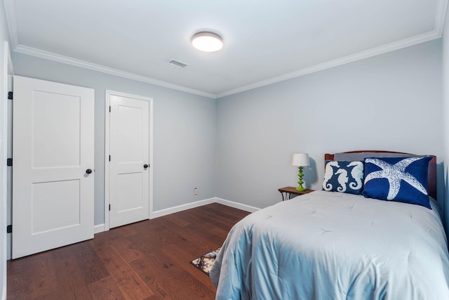 bedroom with baseboards, wood finished floors, and ornamental molding