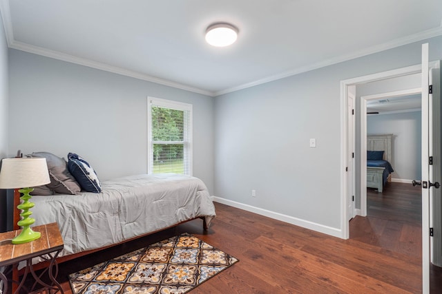 bedroom featuring crown molding, wood finished floors, and baseboards