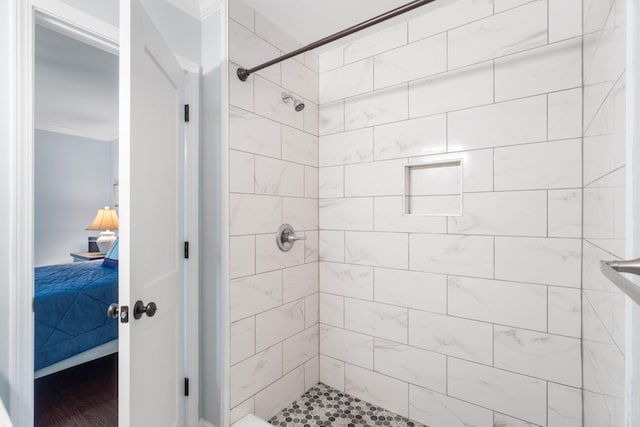 bathroom with a stall shower, ensuite bathroom, and crown molding