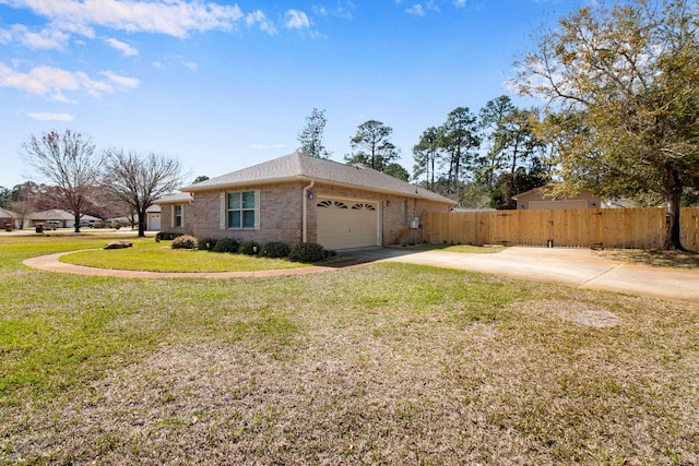 view of home's exterior with brick siding, fence, a garage, a yard, and driveway