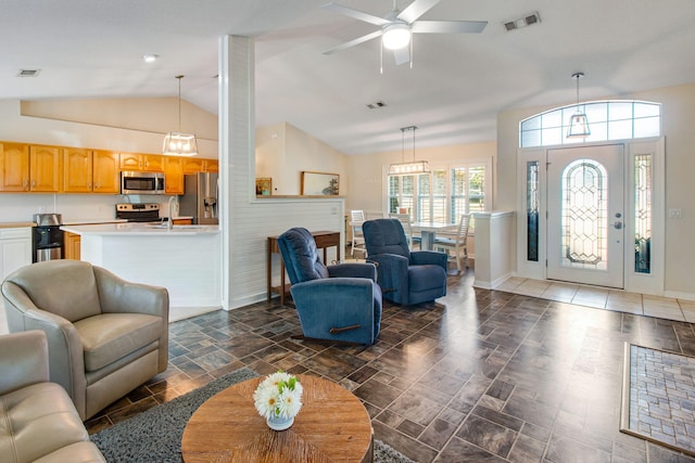 living room with vaulted ceiling, baseboards, and visible vents