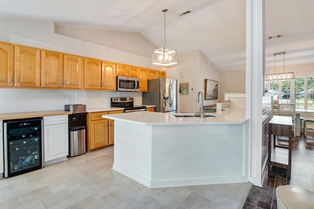 kitchen featuring a sink, visible vents, appliances with stainless steel finishes, and beverage cooler