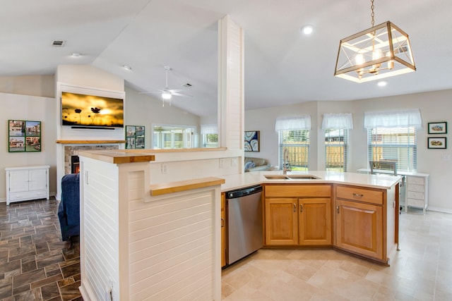 kitchen featuring a sink, lofted ceiling, dishwasher, and light countertops