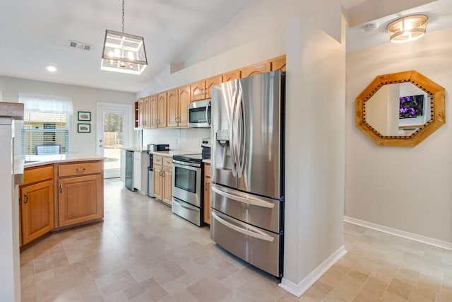 kitchen featuring baseboards, visible vents, lofted ceiling, stainless steel appliances, and light countertops