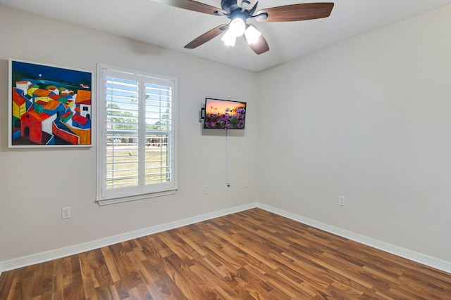 spare room with a ceiling fan, wood finished floors, and baseboards