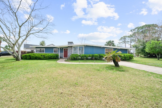 single story home with a front yard, driveway, and a chimney