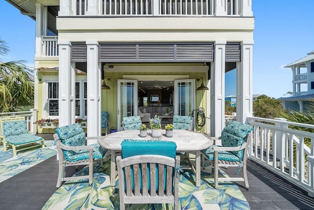 view of patio featuring a balcony and outdoor dining space