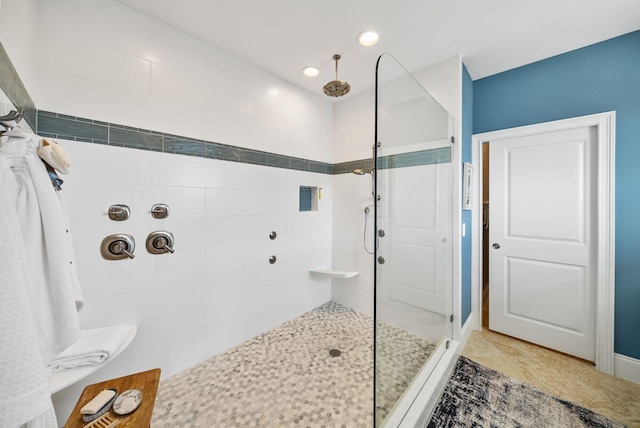 full bathroom with recessed lighting and a tile shower