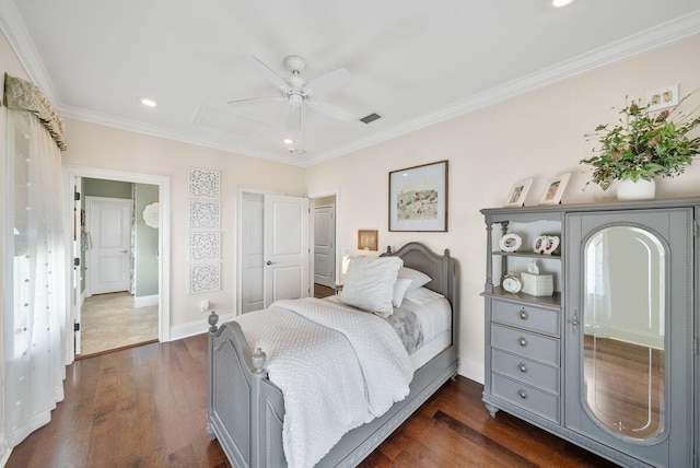 bedroom featuring visible vents, baseboards, dark wood finished floors, and ornamental molding