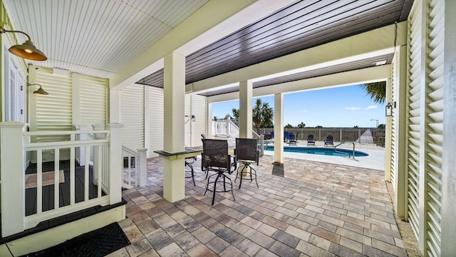 view of patio featuring fence and a fenced in pool