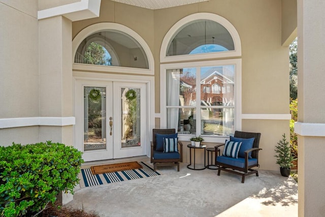 doorway to property featuring french doors and stucco siding