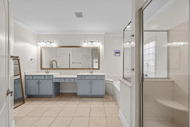 bathroom with tile patterned flooring, visible vents, ornamental molding, and a sink