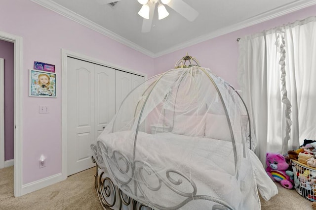 bedroom featuring visible vents, crown molding, baseboards, light colored carpet, and a closet