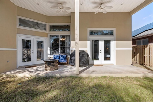 rear view of property featuring stucco siding, french doors, and fence