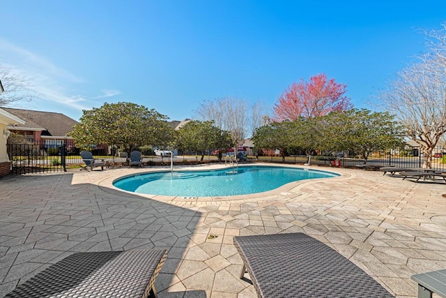 pool featuring a patio area and fence