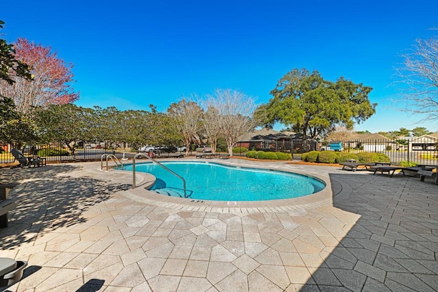 pool featuring a patio area and fence