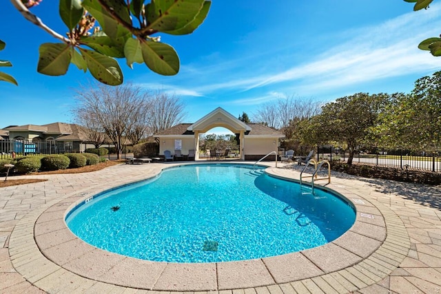 pool featuring a patio area and fence