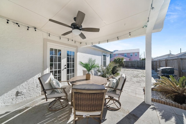 view of patio / terrace with a fenced backyard, outdoor dining space, french doors, and ceiling fan