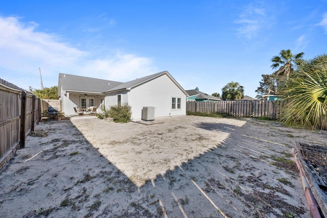 view of yard with central air condition unit, french doors, a patio, a fenced backyard, and a ceiling fan