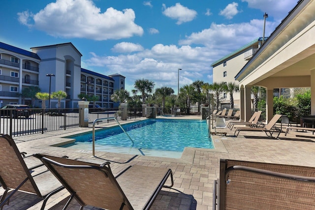 pool featuring a patio area and fence