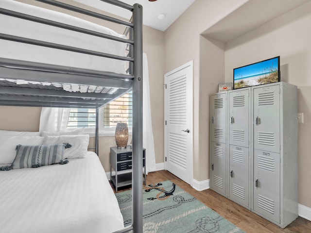 bedroom featuring baseboards and wood finished floors