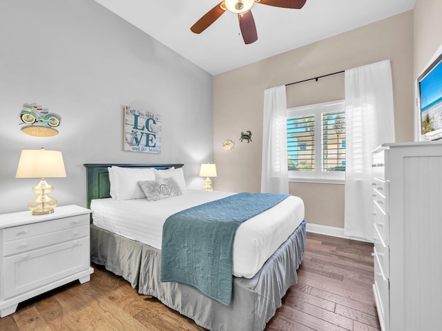 bedroom featuring baseboards, a ceiling fan, and hardwood / wood-style flooring