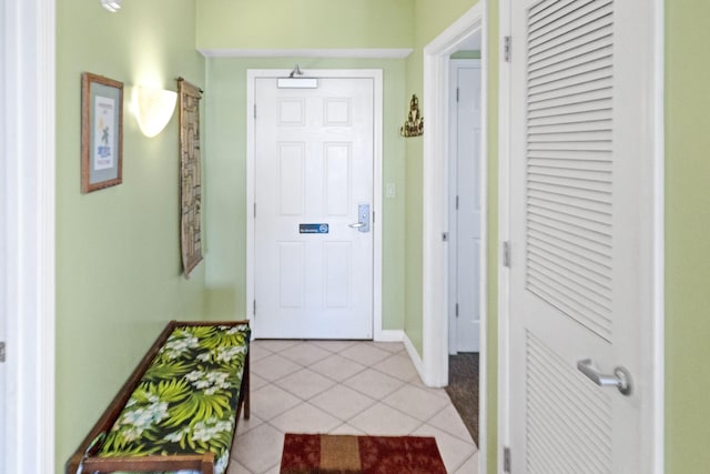 interior space with light tile patterned floors and baseboards