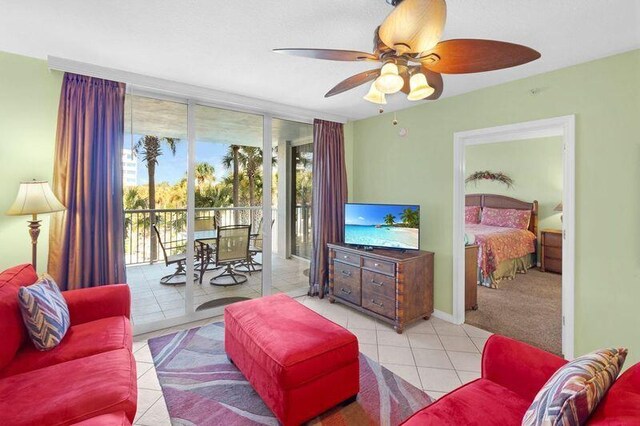 tiled living area featuring a wall of windows, baseboards, and ceiling fan