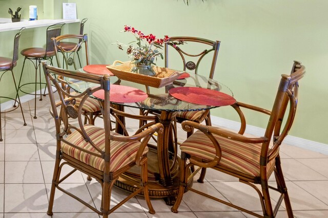 dining area with tile patterned flooring and baseboards