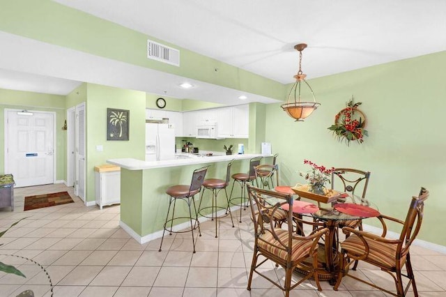 dining room featuring light tile patterned floors, visible vents, recessed lighting, and baseboards