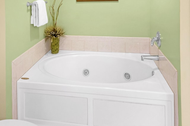 full bath with a whirlpool tub