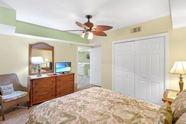 carpeted bedroom featuring a closet, visible vents, and ceiling fan