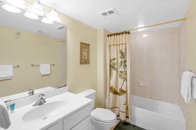 full bath featuring vanity, shower / tub combo, toilet, and visible vents