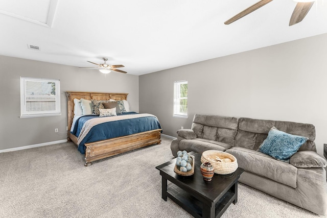 carpeted bedroom featuring visible vents, baseboards, and ceiling fan