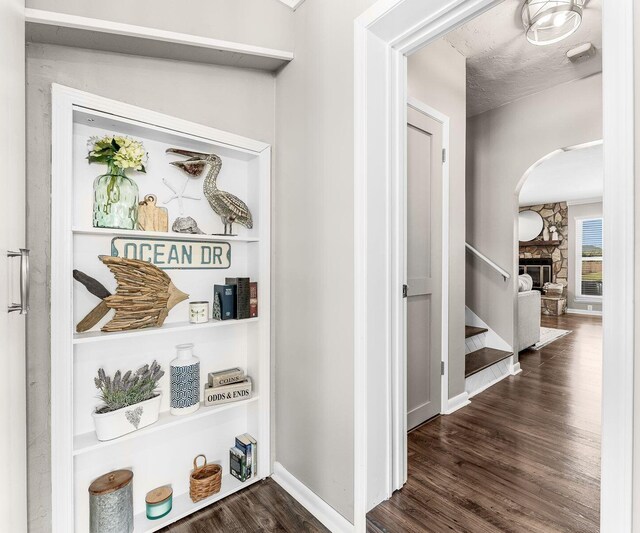 hallway featuring stairs, wood finished floors, and baseboards