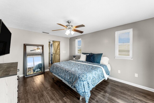 bedroom with visible vents, ceiling fan, baseboards, and wood finished floors