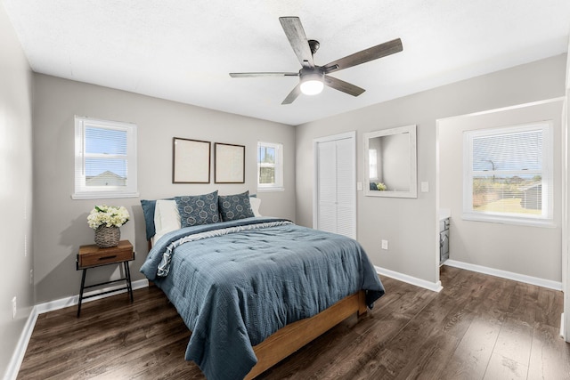 bedroom featuring a ceiling fan, wood finished floors, a closet, and baseboards