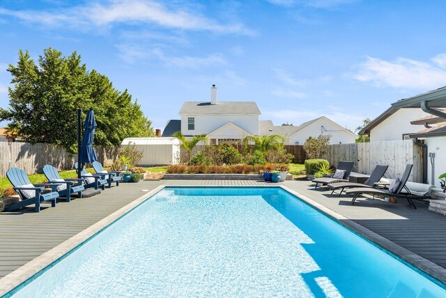 view of swimming pool featuring a fenced in pool, a fenced backyard, and a patio area