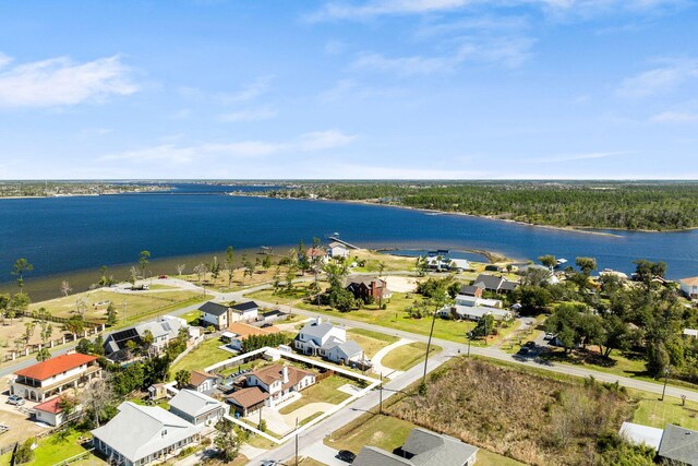 drone / aerial view featuring a water view and a residential view