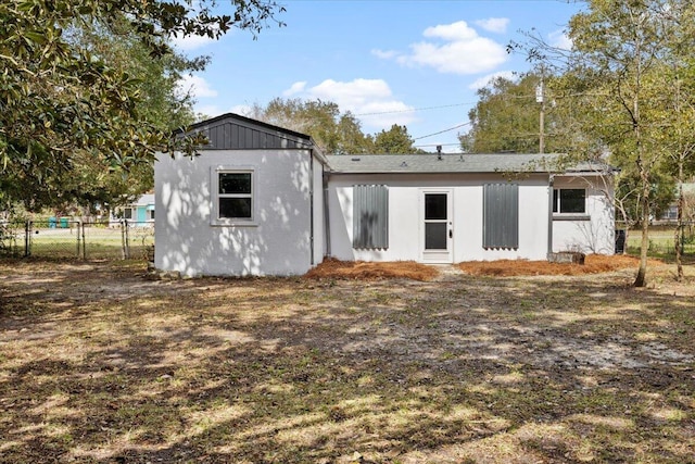 rear view of house with fence