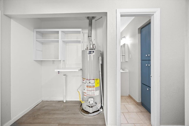 utility room featuring gas water heater