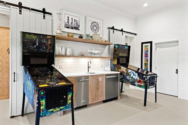 bar with brick wall, a sink, stainless steel dishwasher, a barn door, and tasteful backsplash